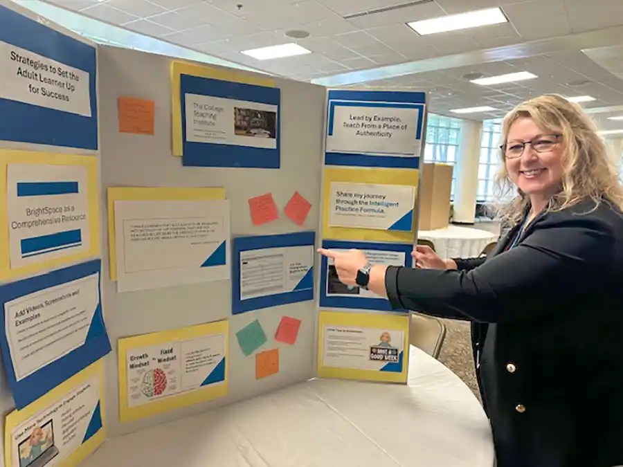 A photo of Dr. Michelle McGuffin with her poster project for 2025 PACE College Teaching Institute