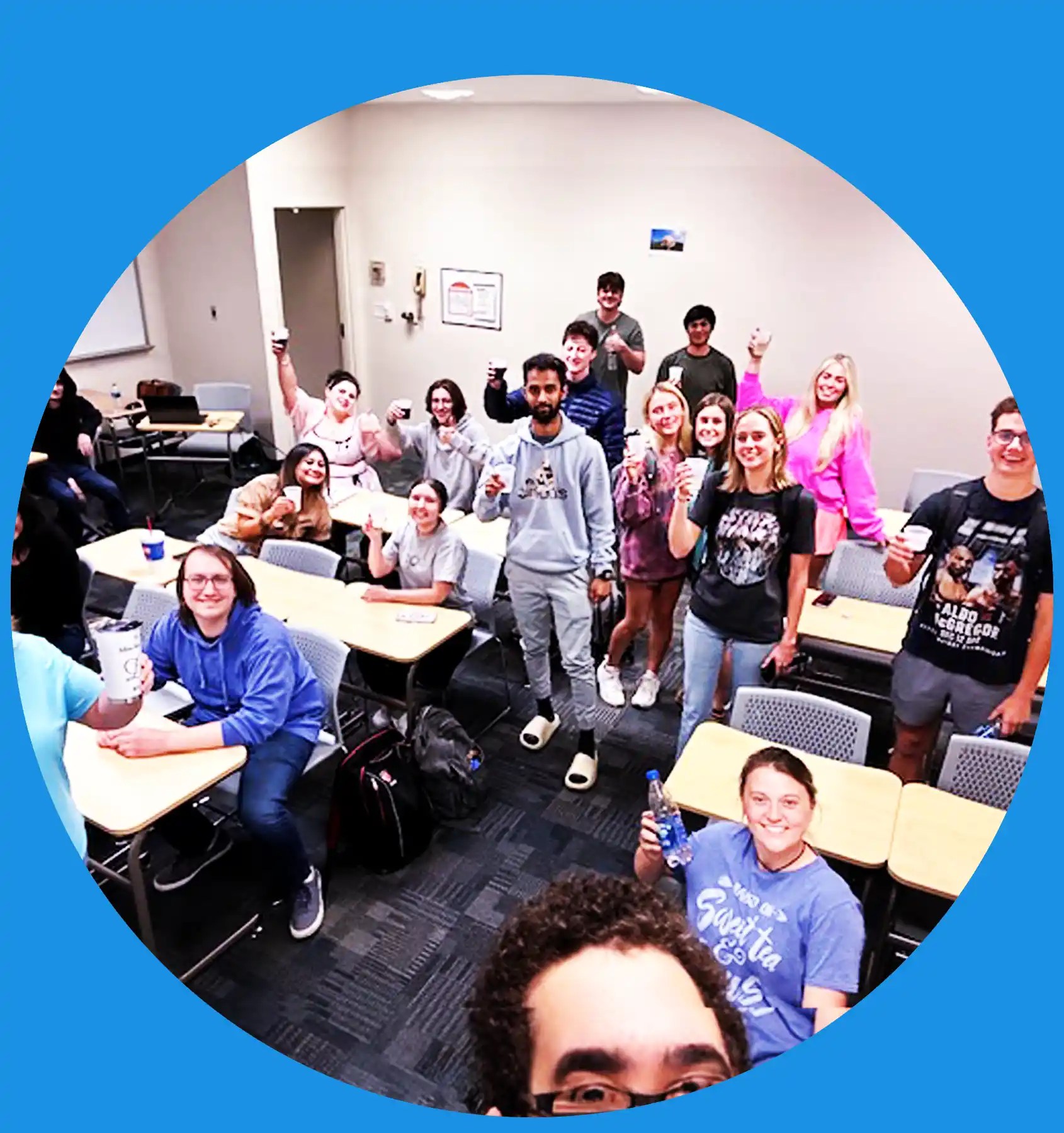 A photo of a group of Michelle McMuffin students raising their glasses in a toast